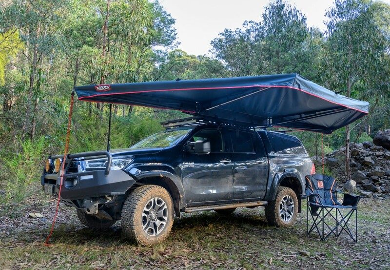 Toyota HiLux with bull bar, canopy and awning set up for touring in the bush