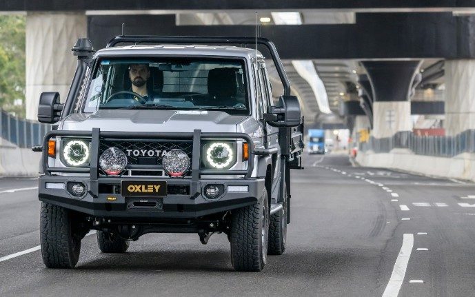 Toyota LandCruiser 70 Series with bull bar and driving lights on the road